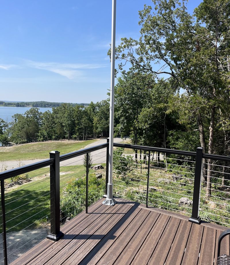 A deck with cable railing overlooking open water
