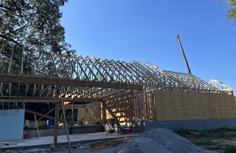 A long run of roof trusses set across a wide new building