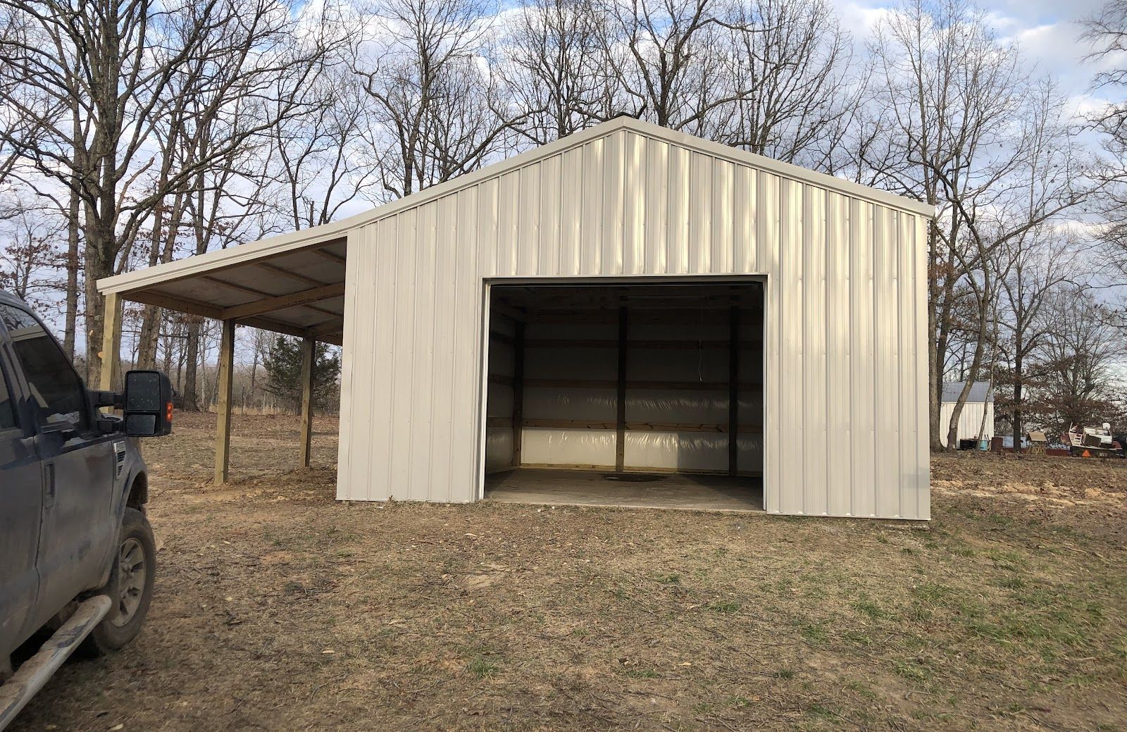 A finished post-frame shop with metal roof and siding